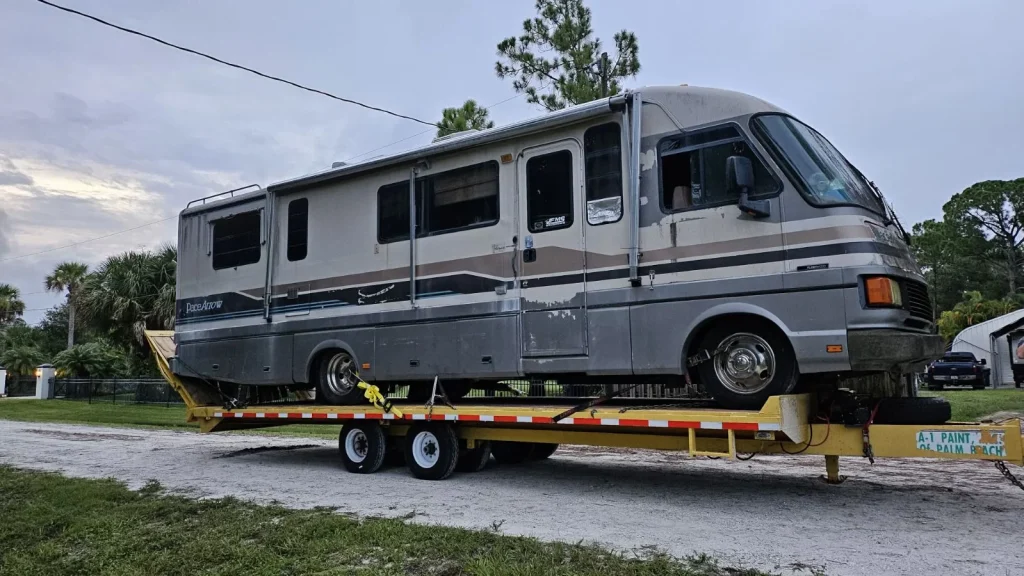 Pro Junk Dispatch safely towing an RV to a disposal or recycling center.